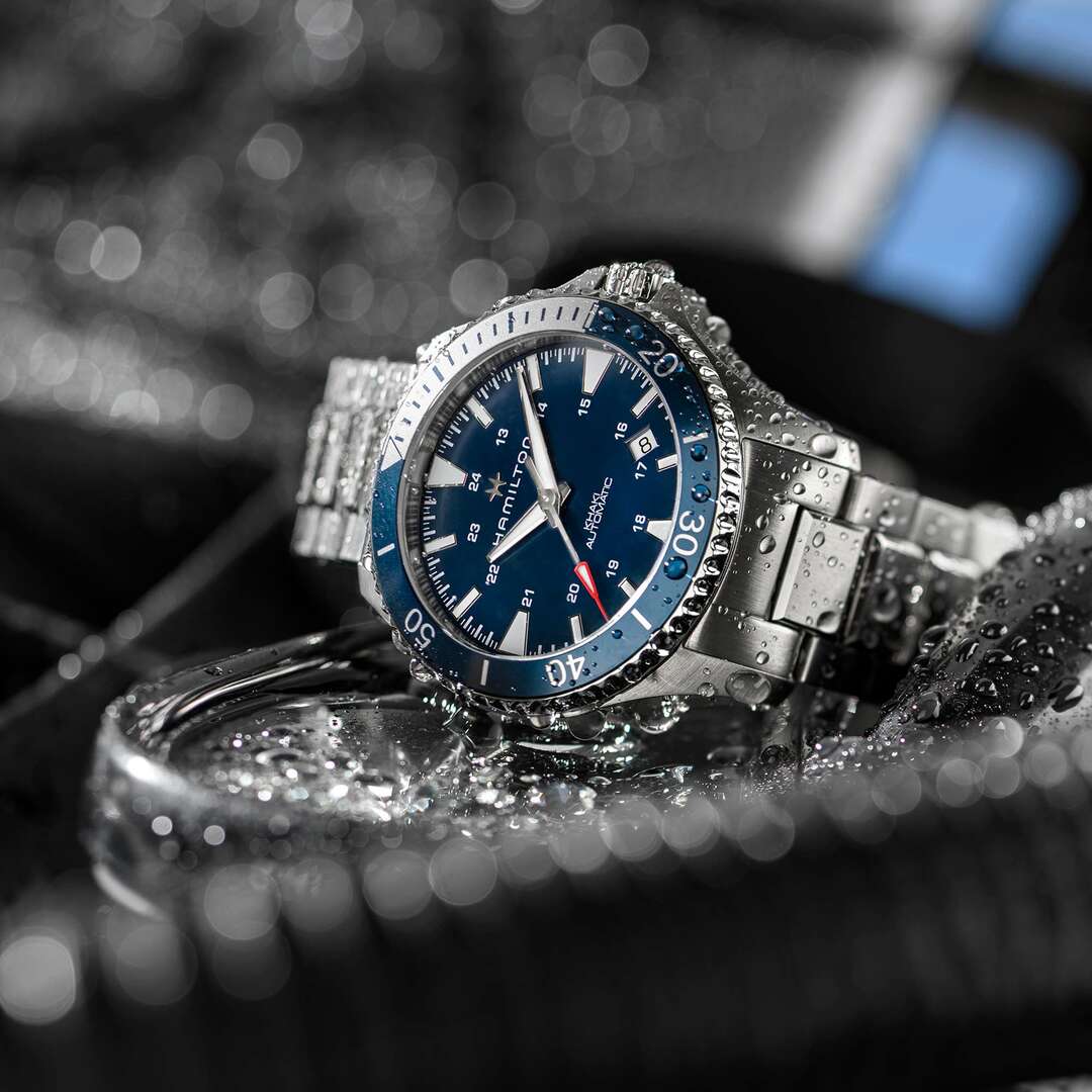 Official Hamilton lifestyle image showing the Khaki Navy Scuba Auto in water-adjacent use.
