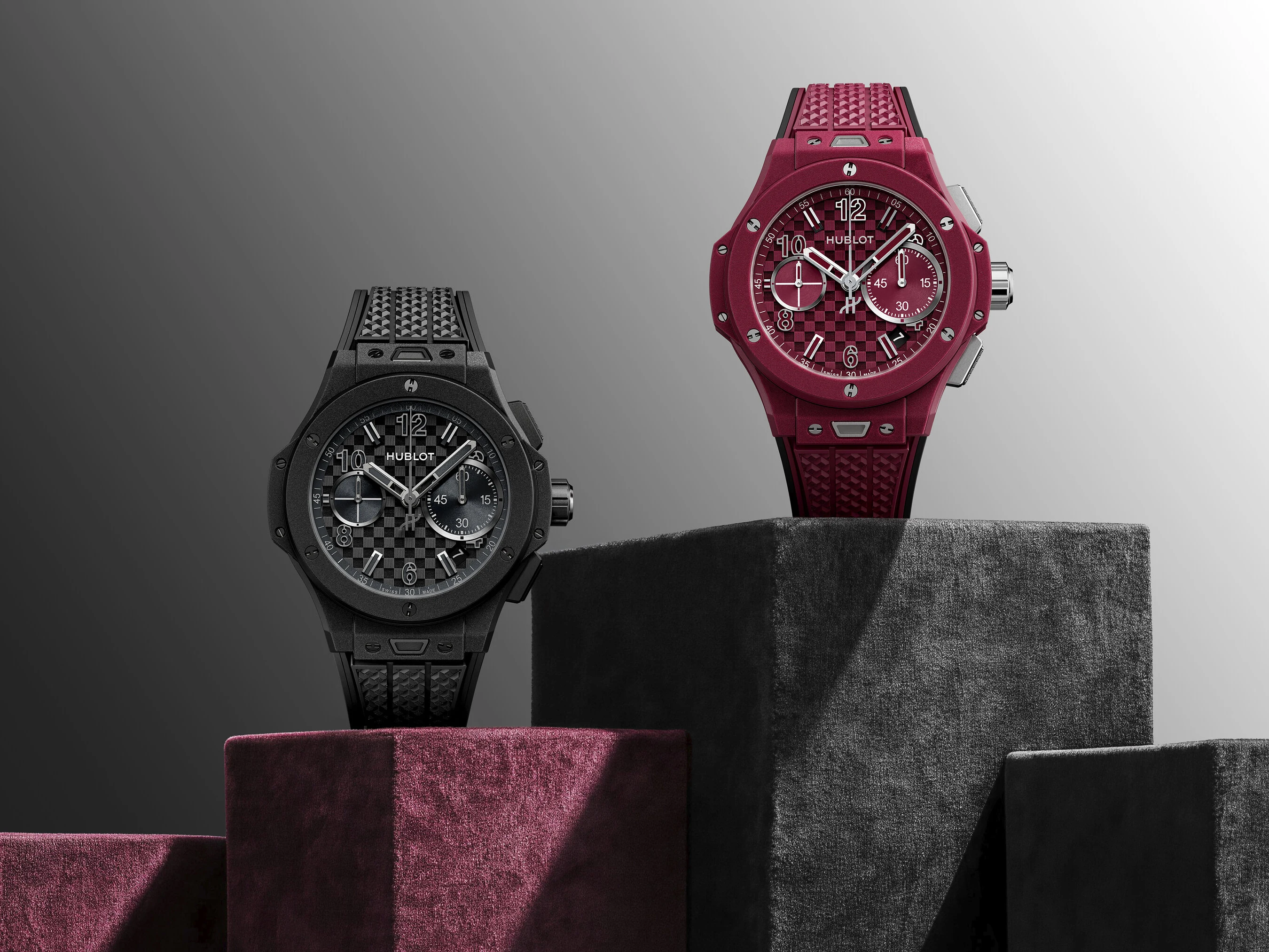 Hublot Big Bang Original Soft Touch All Black and All Red watches on textured blocks