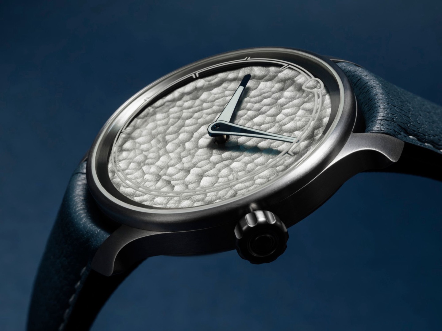 Low side view of the MING 37.06 Royal Selangor showing its hammered pewter dial and brushed titanium case