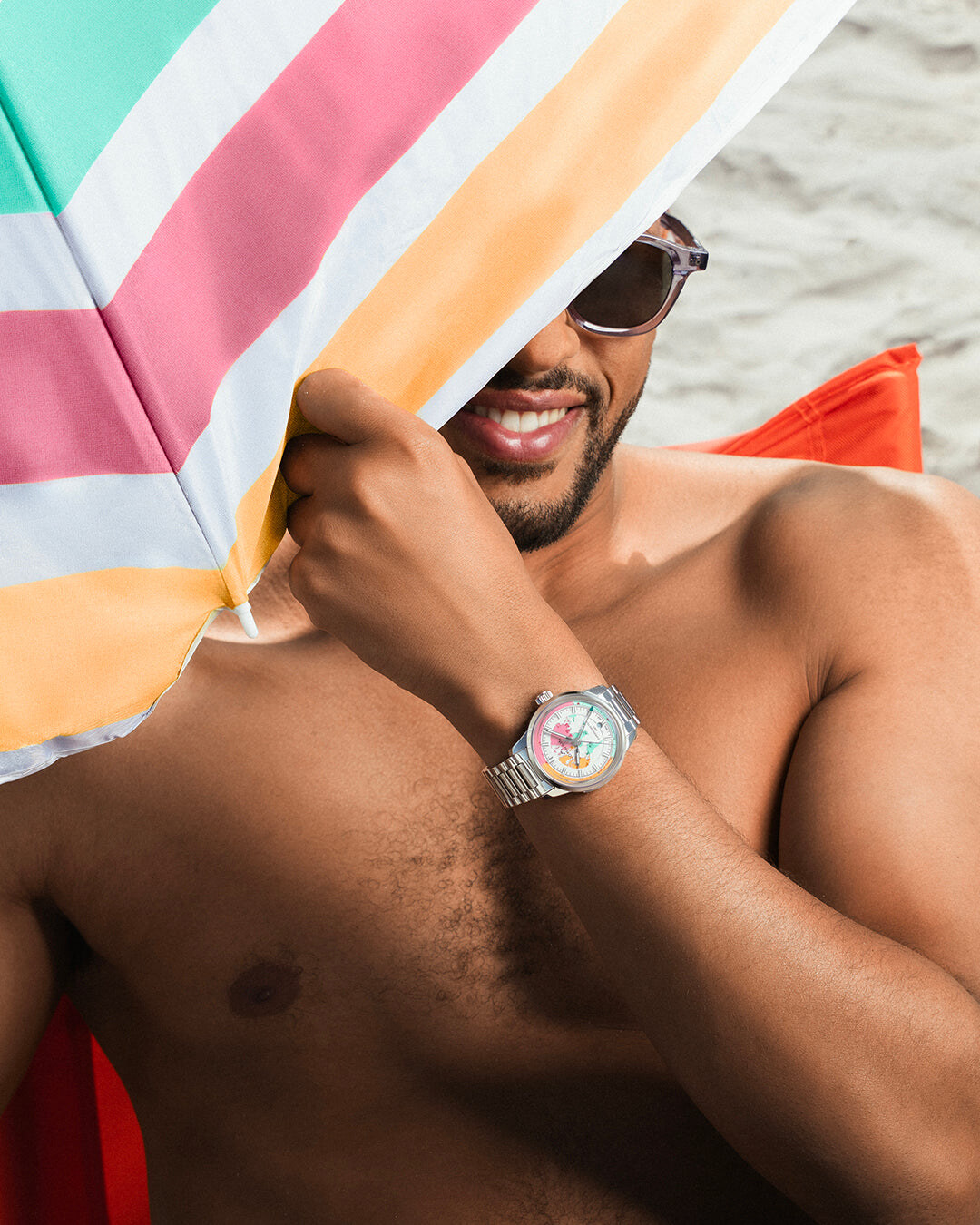 NORQAIN Freedom GMT Enjoy Life Holiday Limited Edition photographed on the wrist in a beach setting