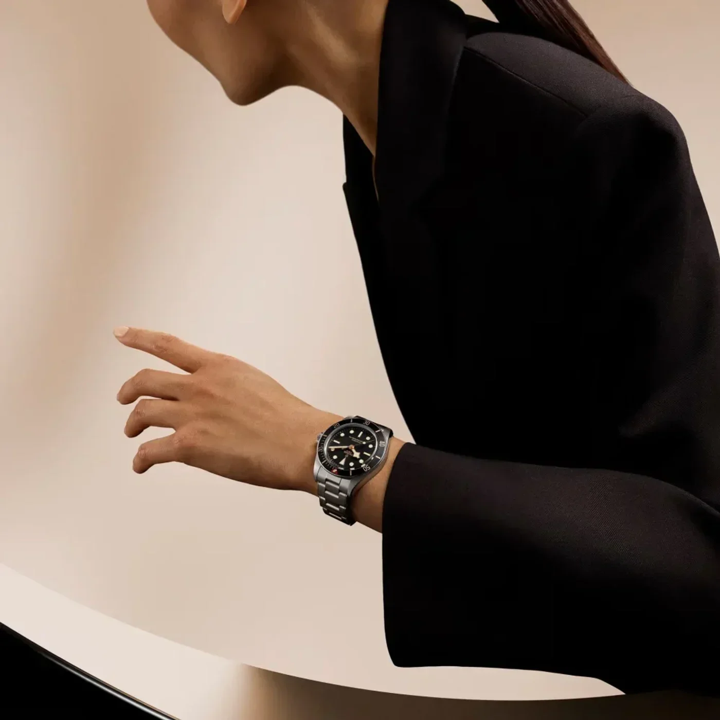 Black Bay 58 worn with tailored clothing, showing how the 39 mm case sits in everyday use. Uğur Saat/TUDOR campaign image.