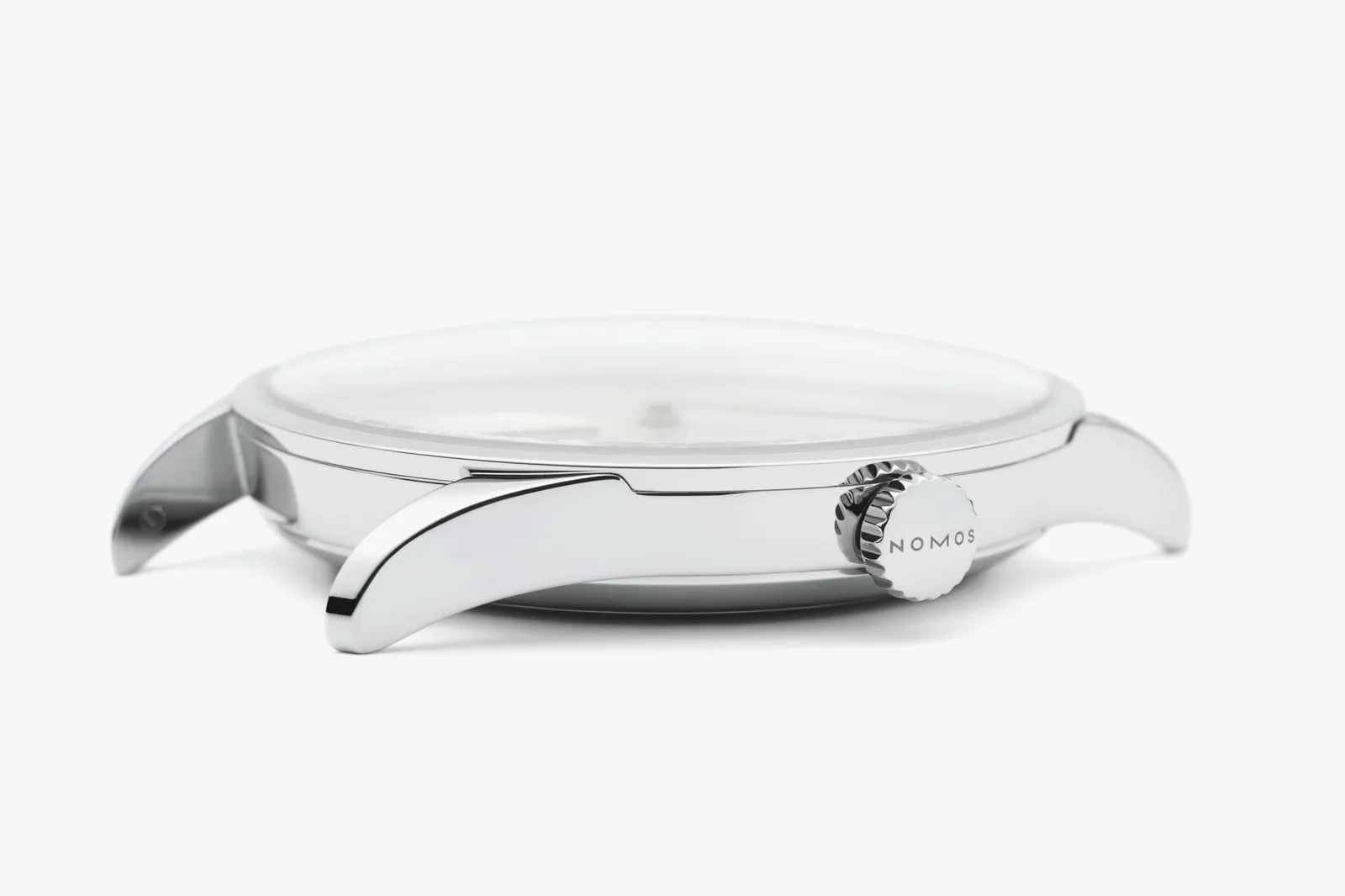 Side view of a NOMOS watch case showing lugs and crown for a lug-to-lug case-size guide.